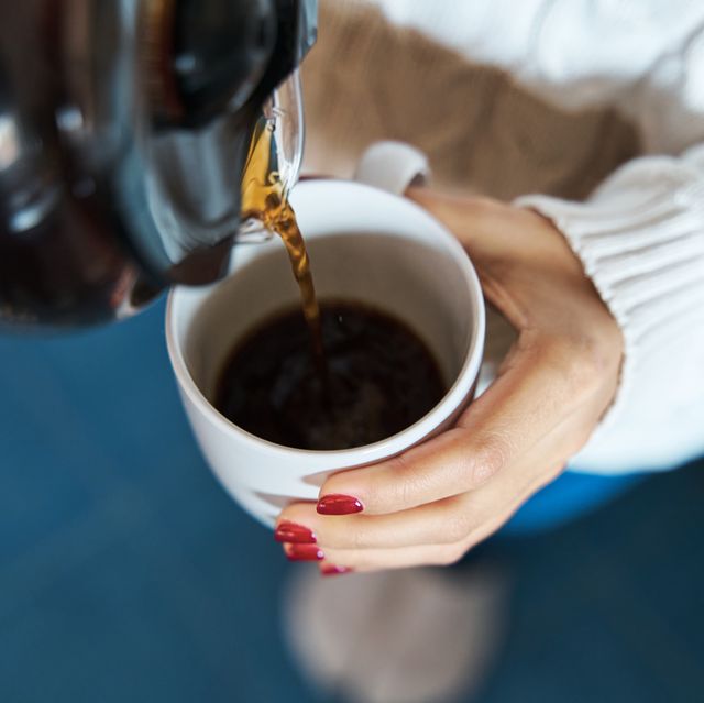 woman pouring herself hot coffee to a mug