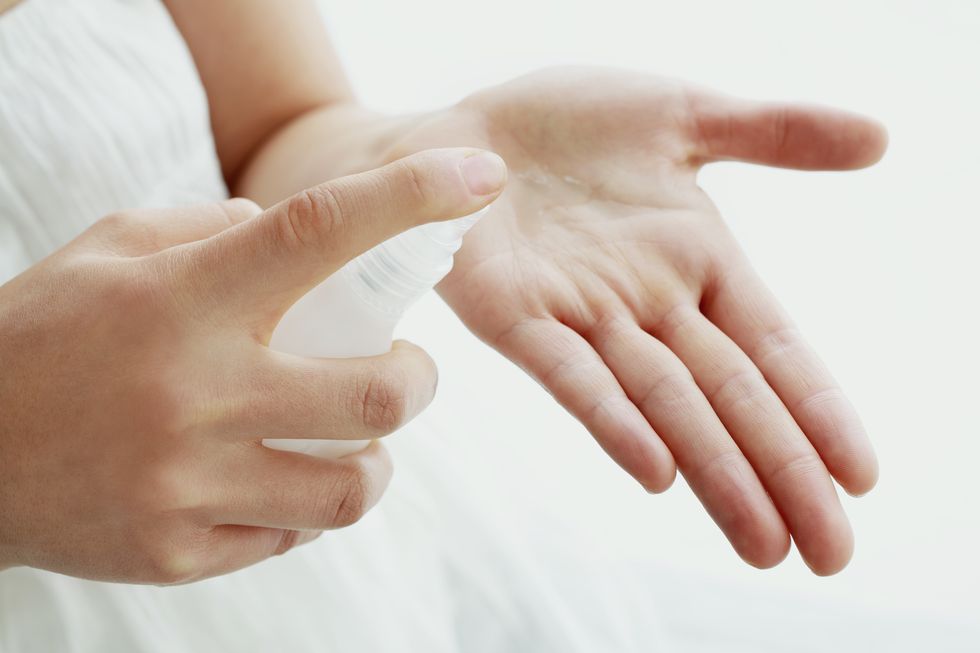 woman pouring lotion into hand, close up