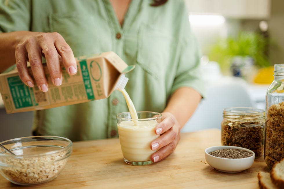 woman pouring milk into a glass