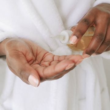 woman pours beauty product into palm of hand
