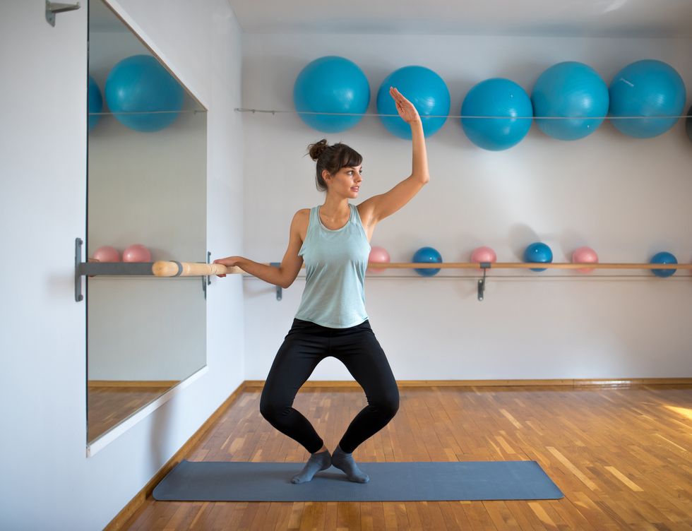 woman practicing barre pilates