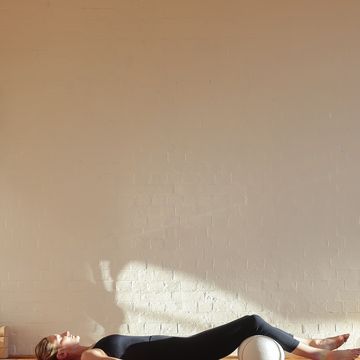 woman practicing yoga and meditation in a yoga studio