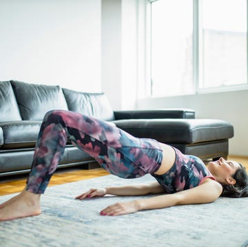 Woman practicing yoga, doing Glute Bridge exercise, dvi pada pithasana at home woman practicing yoga, doing glute bridge exercise, dvi pada pithasana at home