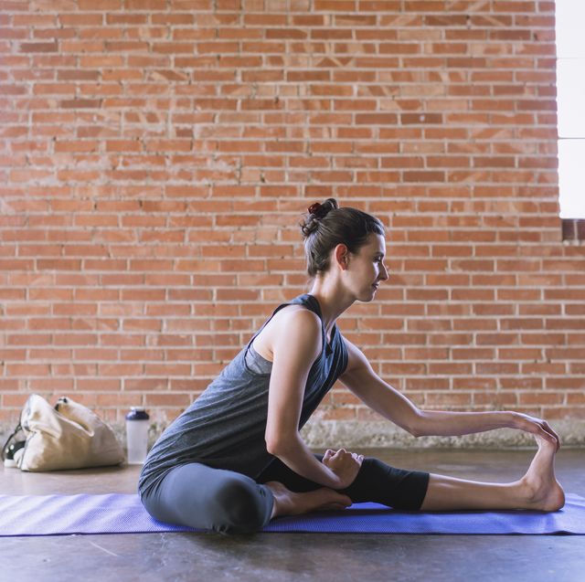 woman practicing yoga in studio
