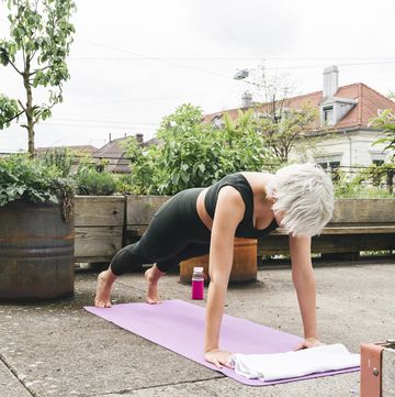 woman practising yoga on a roof terrace