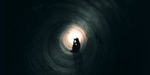 Woman Praying In A Dark Place