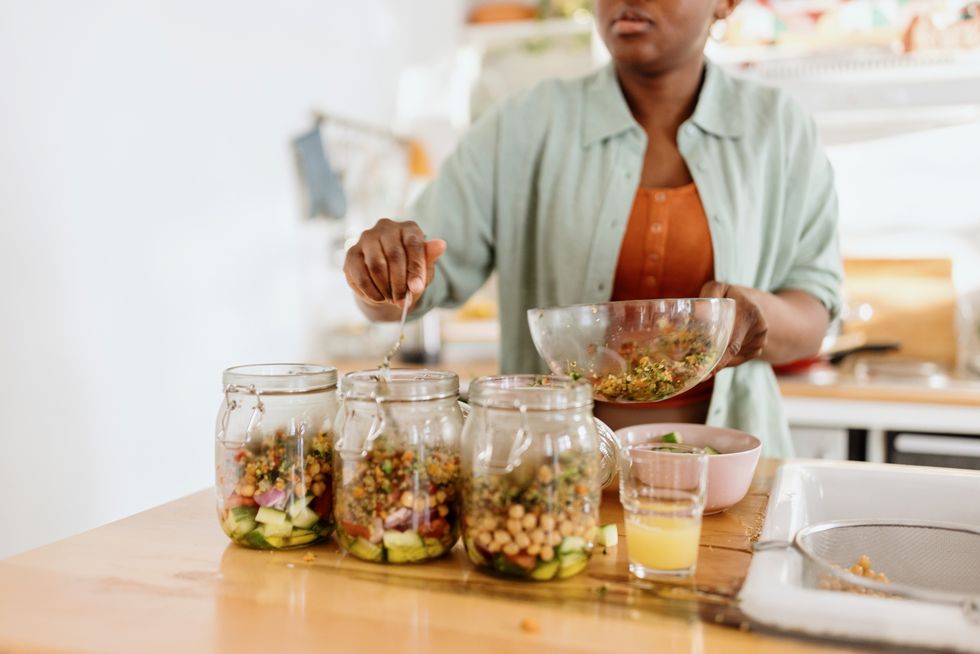 woman preparing a tasty salad in a jar