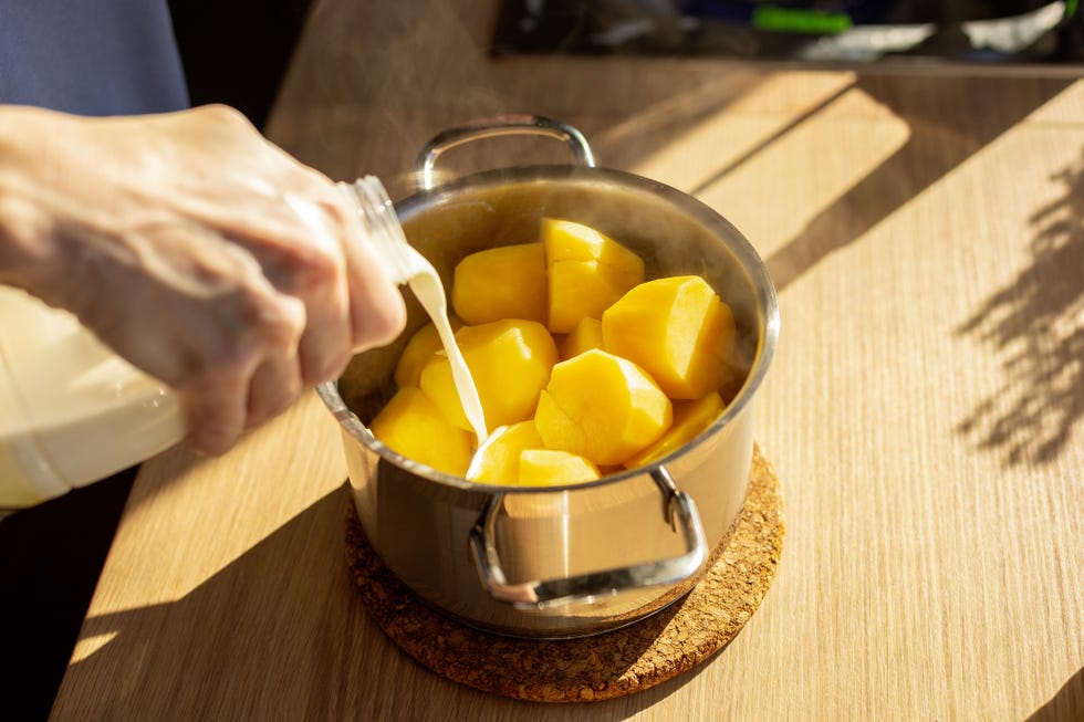 woman preparing mashed potatoes in home kitchen