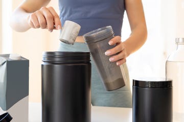 woman preparing protein shake at home