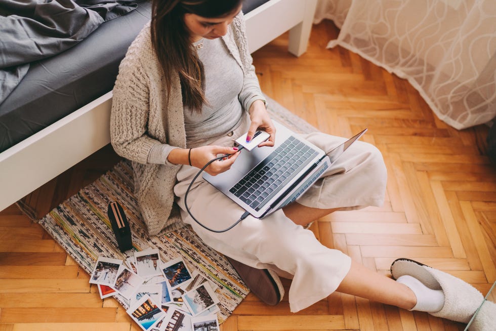 woman printing photos from her laptop