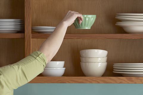 Woman Putting Away Dishes