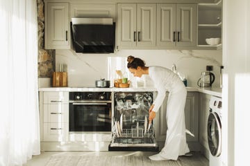 woman putting dishes in dishwasher