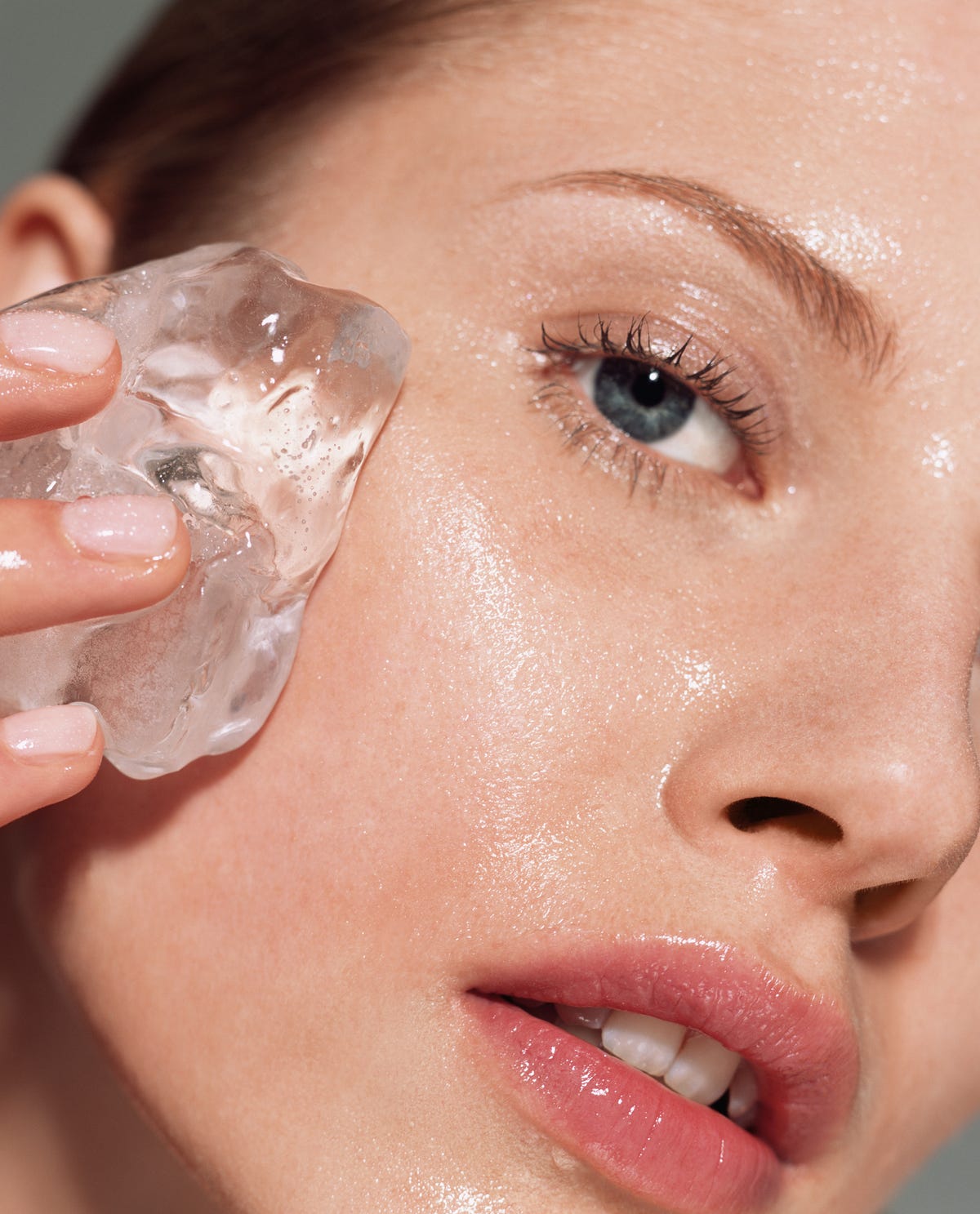 woman putting ice on her face