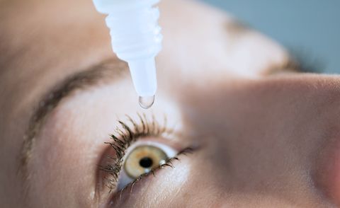 woman putting in eye drops