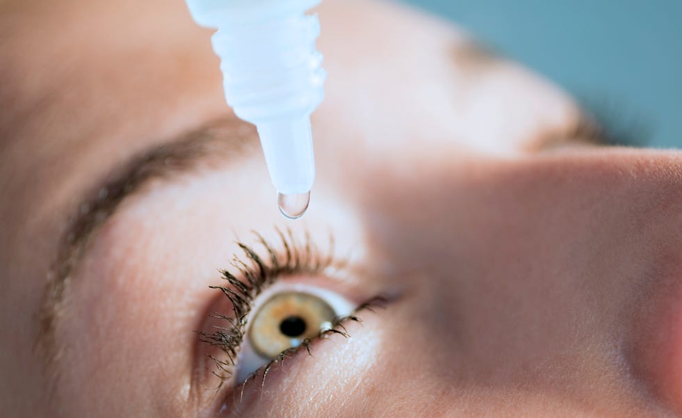 woman putting in eye drops