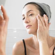 woman putting on face cream