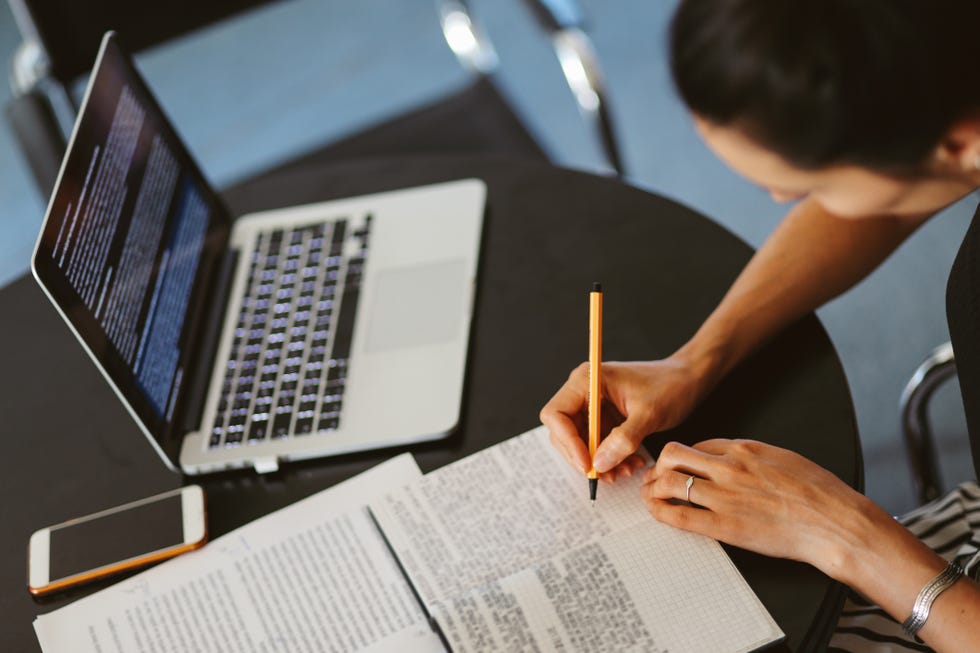 jobs for stay at home moms - Woman reading and working at home