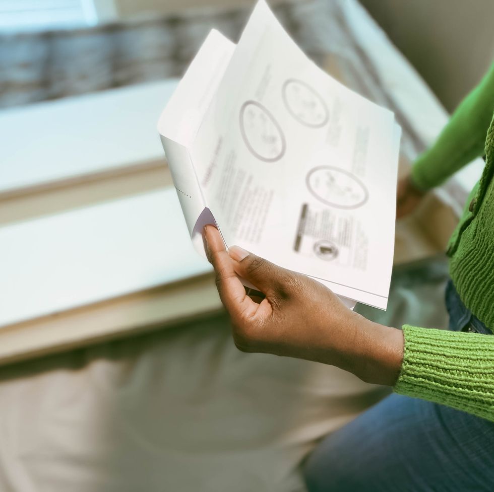 woman reads bookshelf assembly instructions