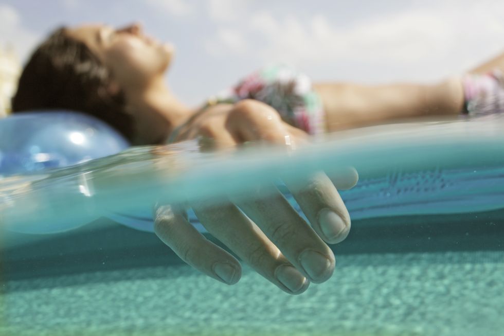 woman relaxing on inflatable in water