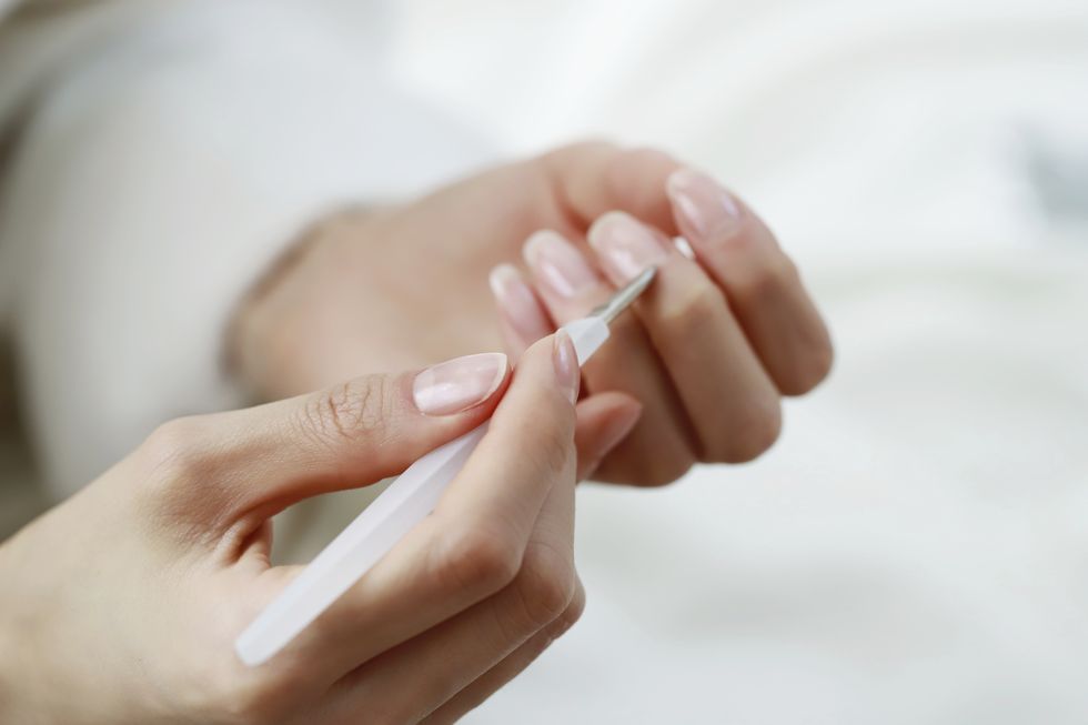 woman removing cuticle