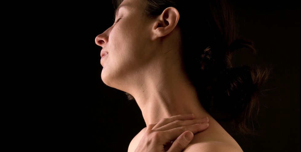 woman rubbing her neck