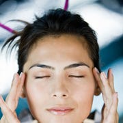 what is eft tapping - Woman rubbing her temples what is eft tapping woman rubbing her temples