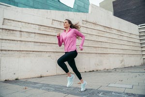 woman running against modern building