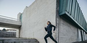 woman running against modern building