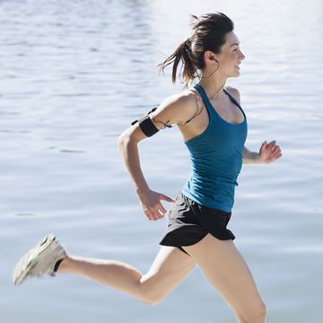 woman running along lake