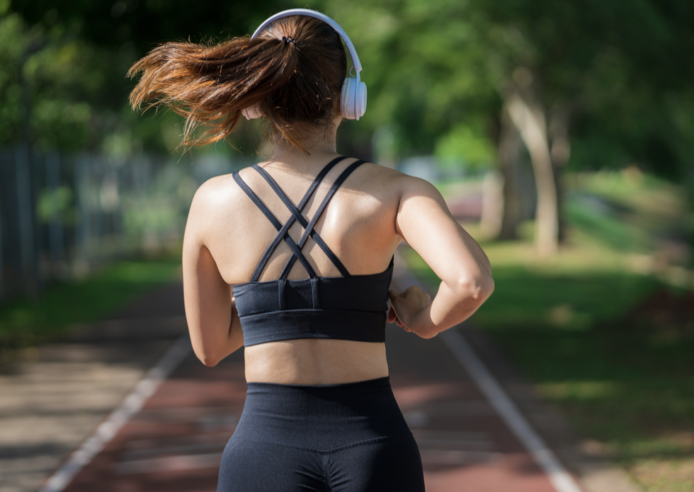 a woman wearing headphones running