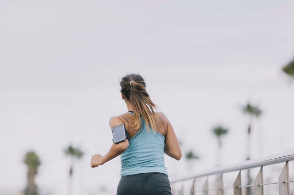woman running for fitness in barcelona city