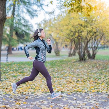 woman running in autumn park