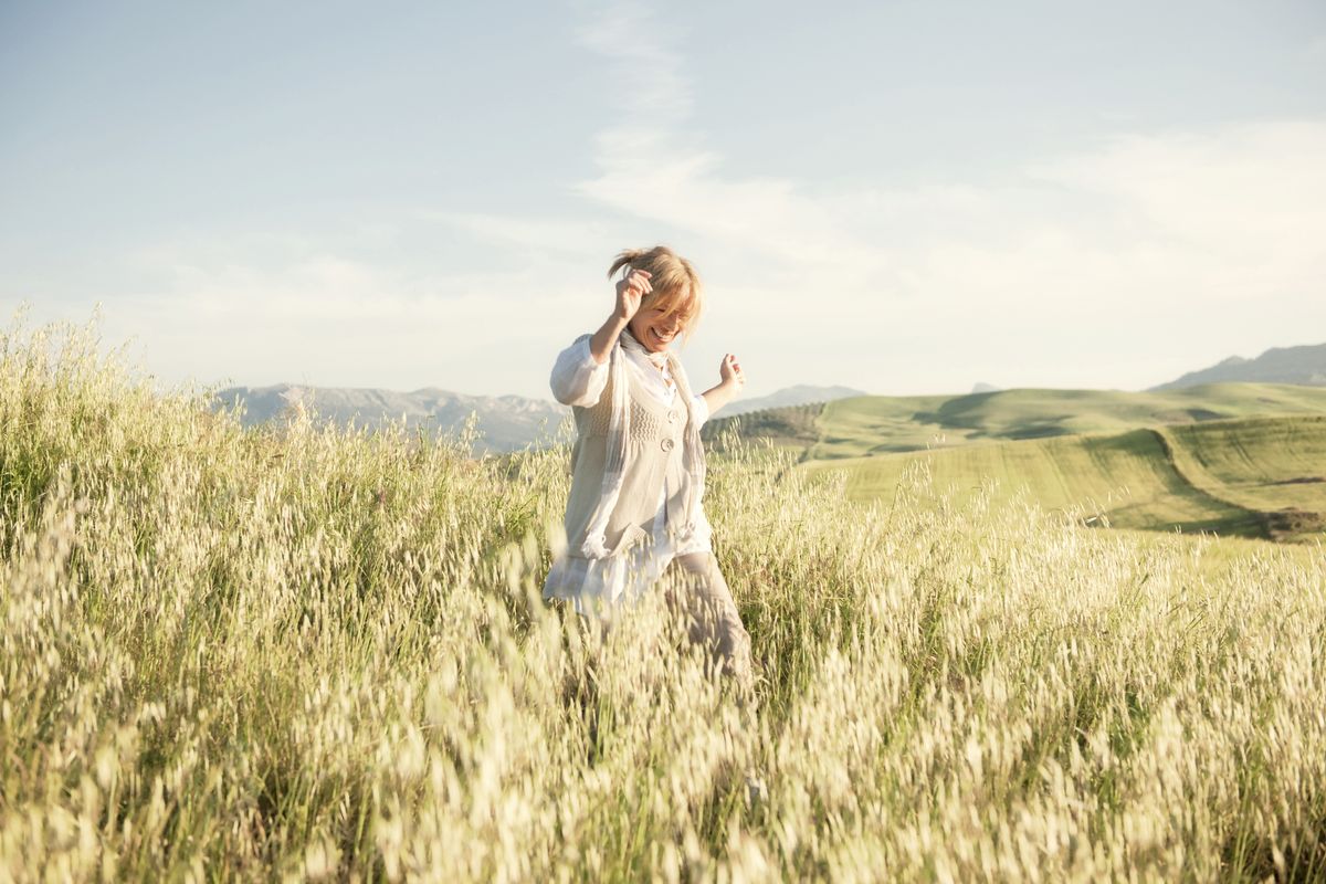 woman running in grassy field