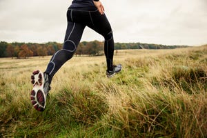 woman running in nature with autumn colors