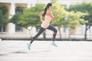 Woman running through city streets