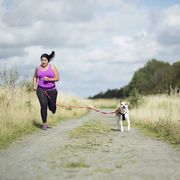 woman running with dog on hands free leash