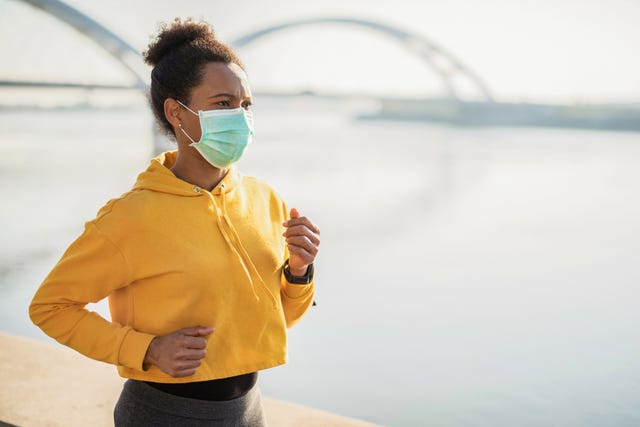 woman running with protective face mask