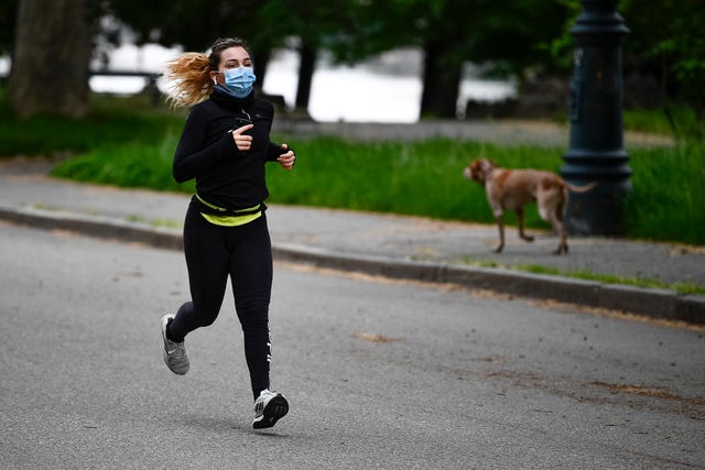 a woman runs at parco del valentino valentino park during