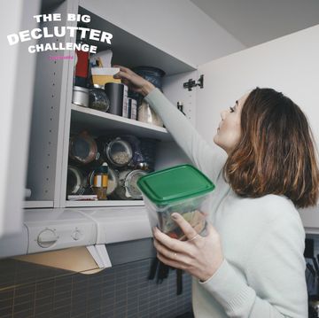 Woman searching kitchen cabinet