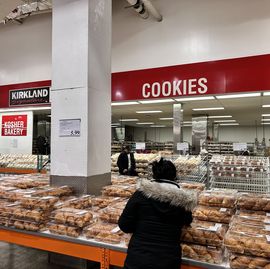 woman selecting croissants recently recalled from costco bakery department, queens, new york
