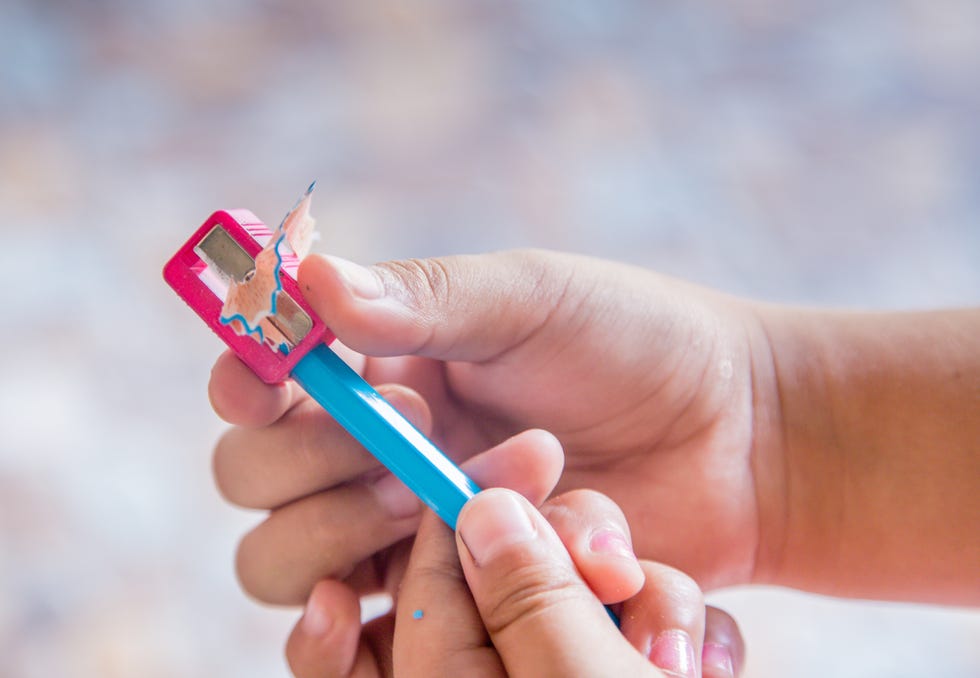 children hand using pencil sharpener