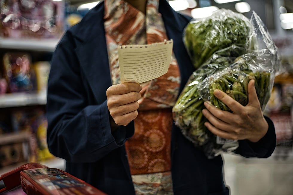 woman shopping for fresh organic vegetables in supermarket