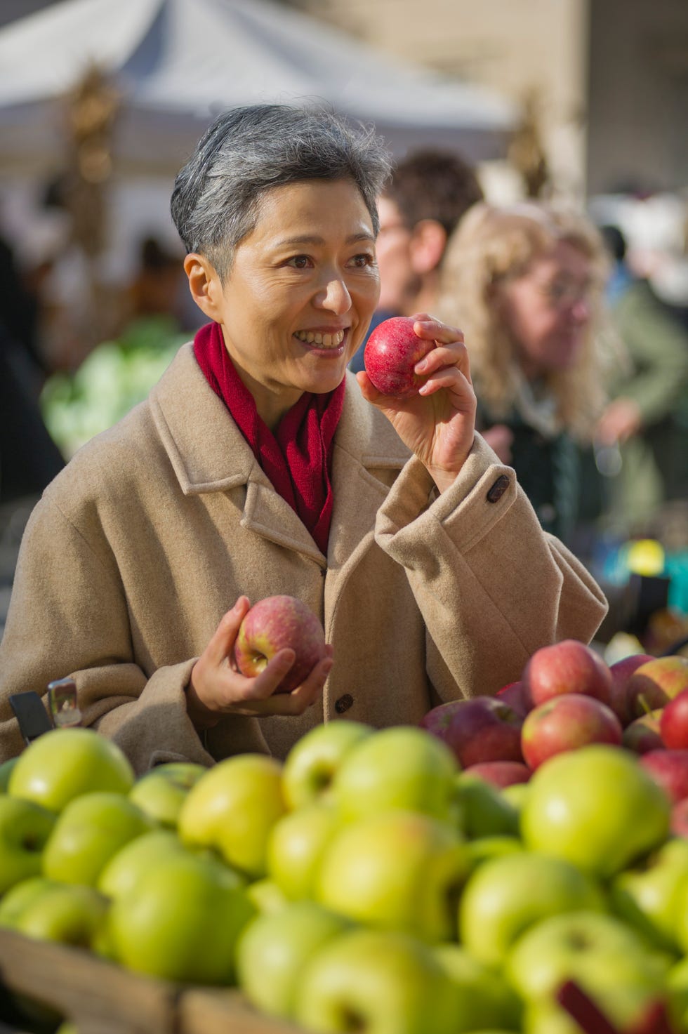 woman shopping for fruit at public market
