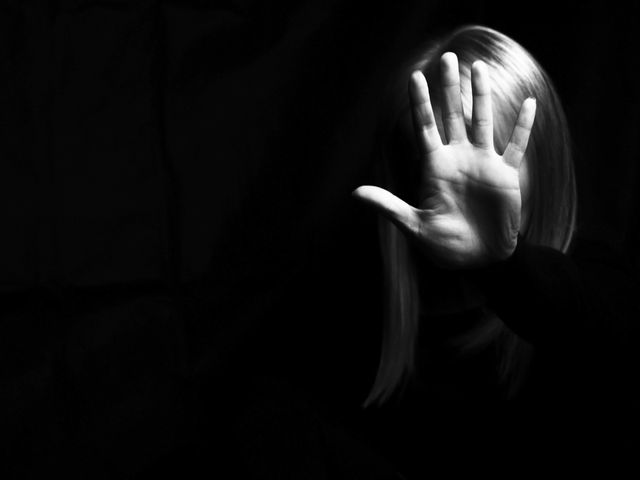 a woman showing gesture stop violence against women concept