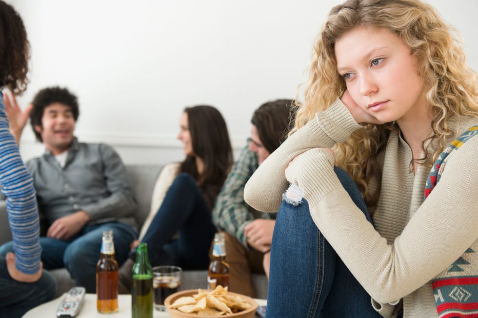 woman sitting apart from friends