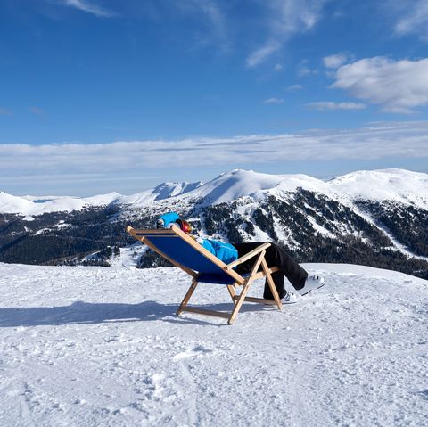 woman sitting in a chair in snow