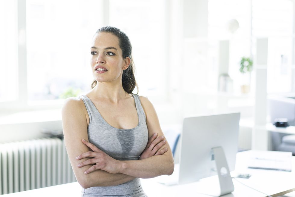 Woman sitting in office after workout