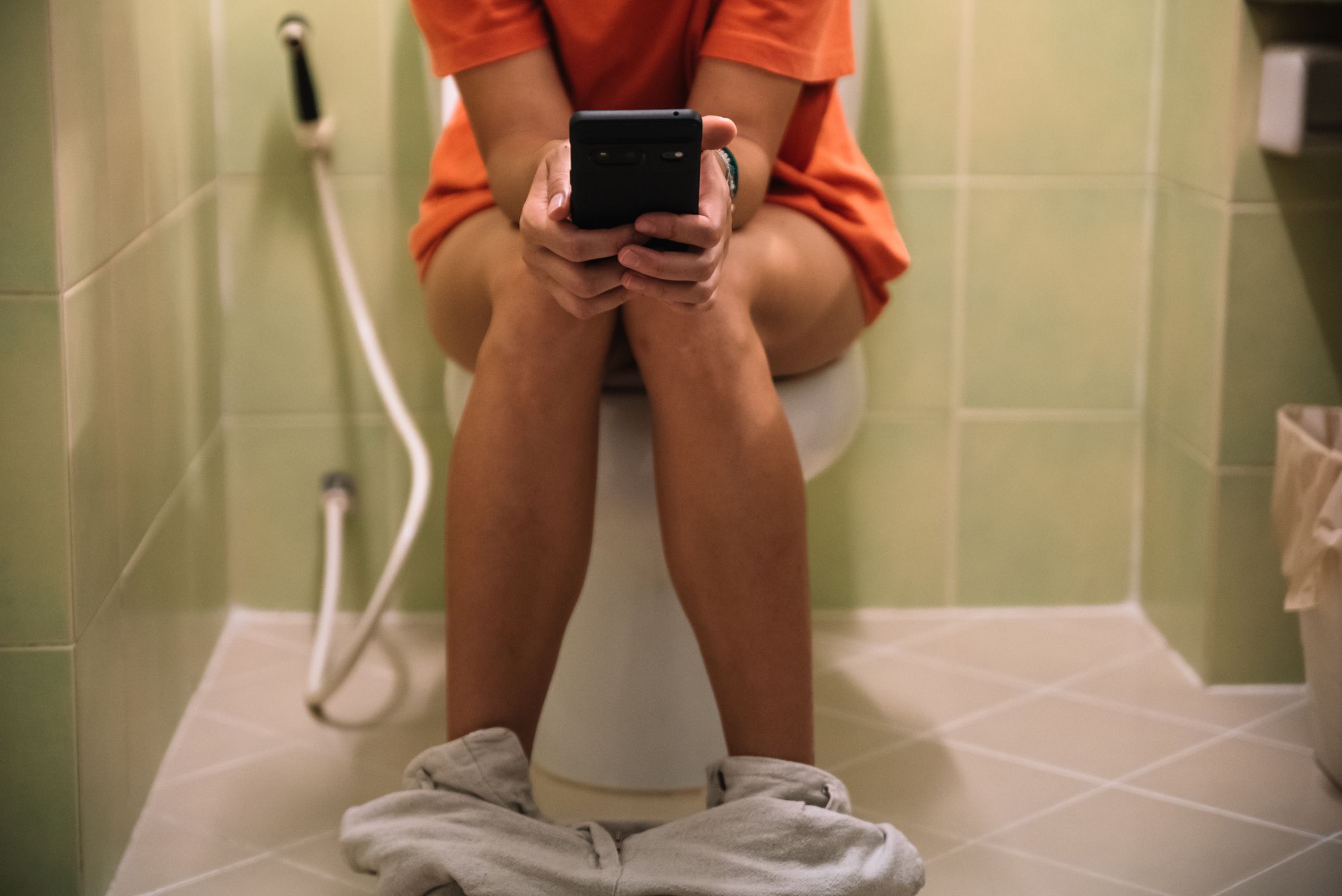 Little girl next to children's toilet with panties around ankles