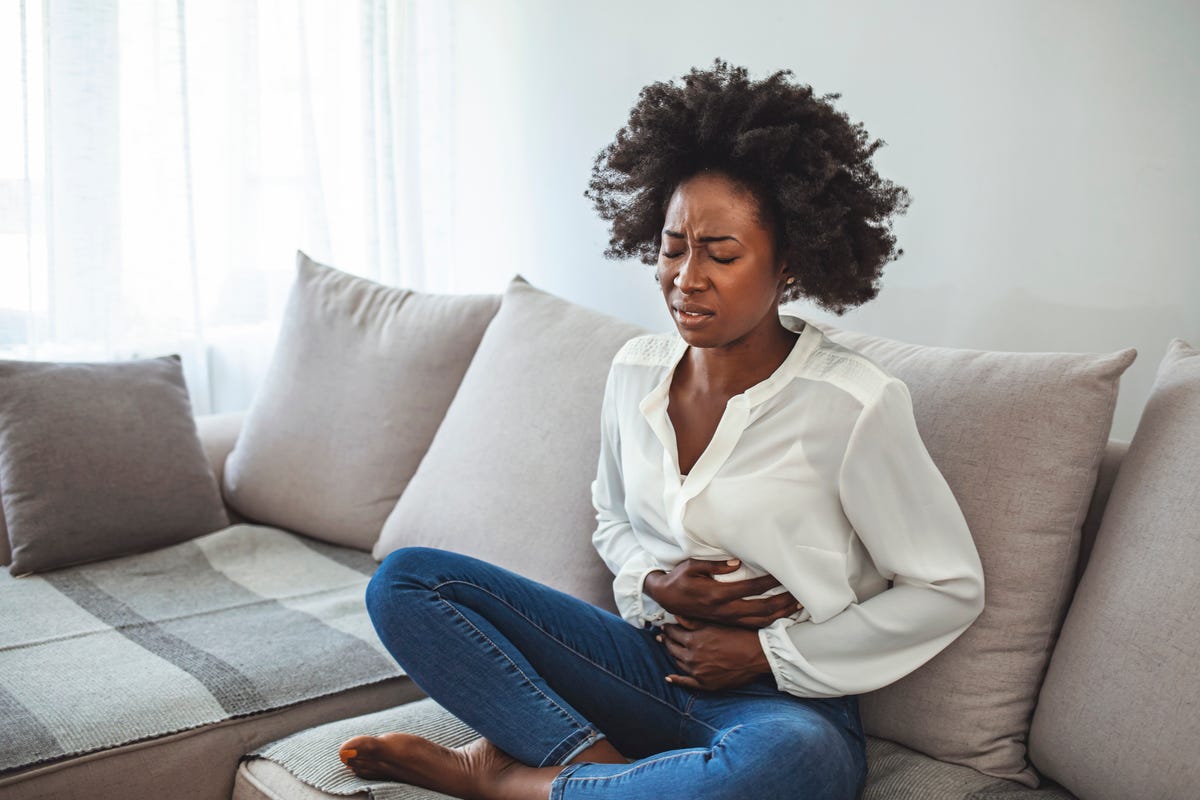 Free Photo  Woman holds pain killers and tampon suffers from