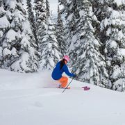 woman skiing fresh powder on a ski vacation